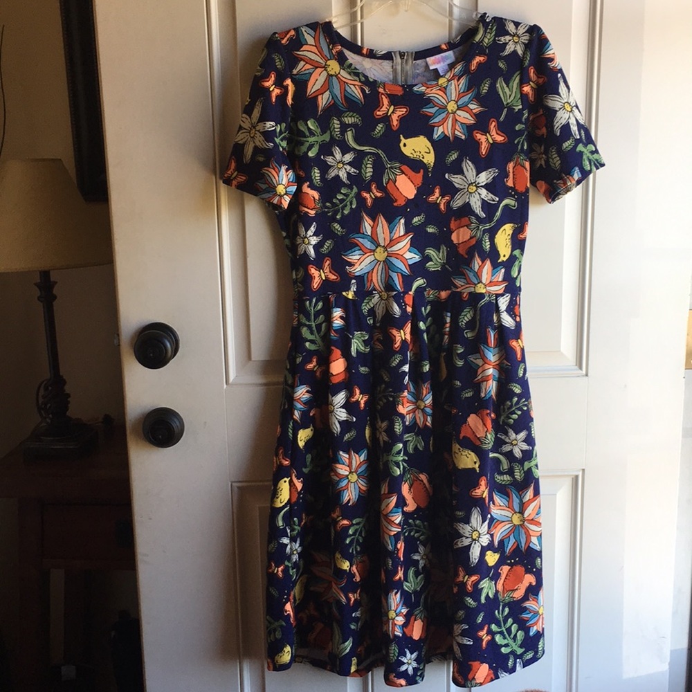 Fit and flare dress zipper up the back pockets.